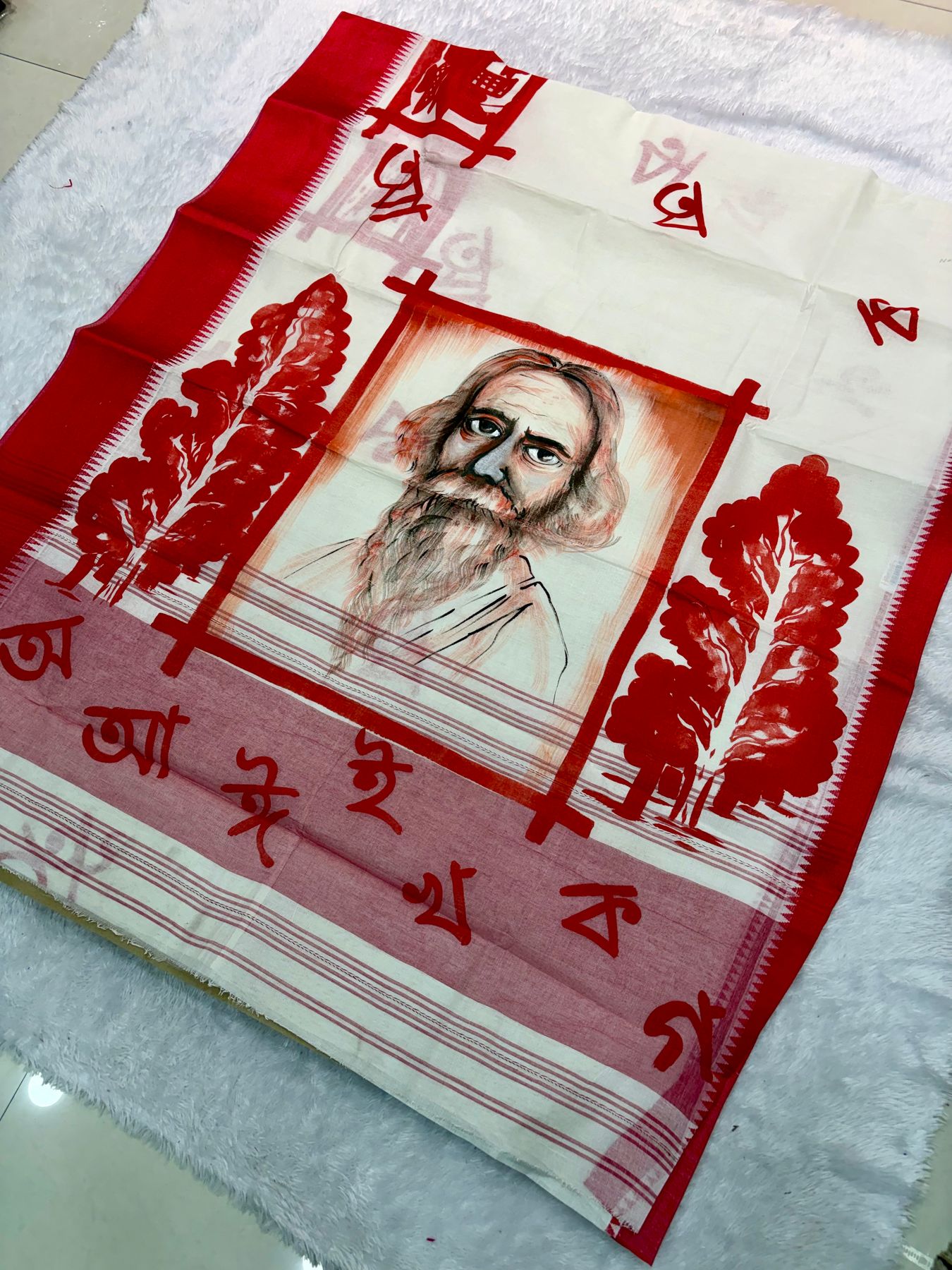 Hand-painted saree with a portrait of Tagore and Bengali letters